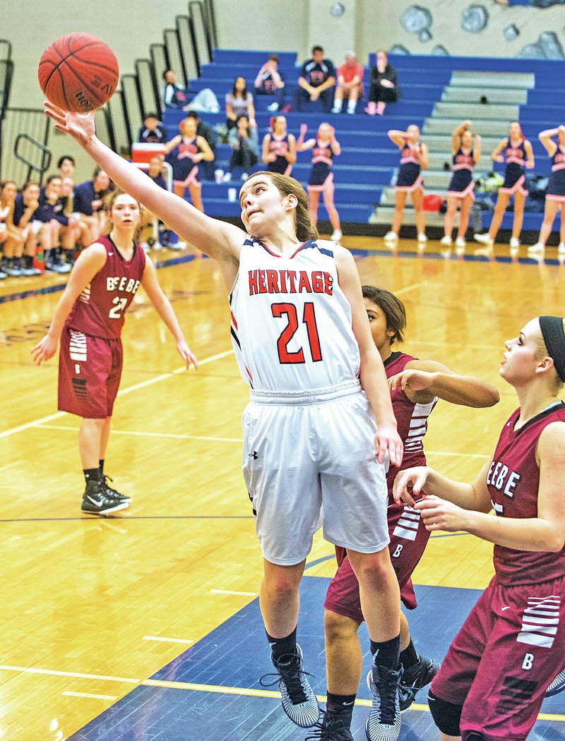 STAFF PHOTO ANTHONY REYES &#8226; @NWATONYR Dehring Scudder, Rogers Heritage junior, grabs a rebound Thursday against Beebe during the Rogers Great 8 Tournament at King Arena in Rogers.