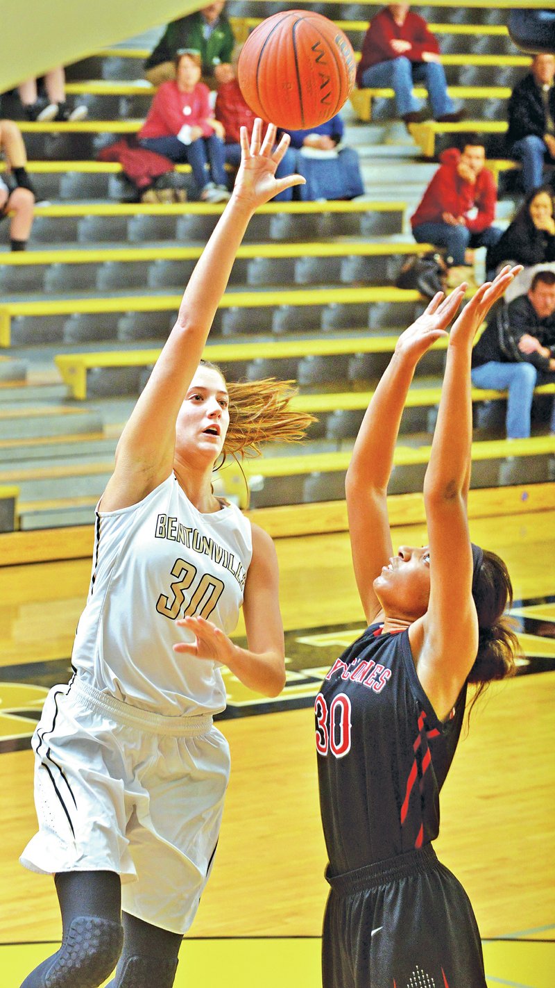 STAFF PHOTO BEN GOFF &#8226; @NWABenGoff Madison Brittain, left, of Bentonville shoots Thursday over Shameka Ealy of Russellville during the Crabtree Invitational tournament at Tiger Arena in Bentonville.