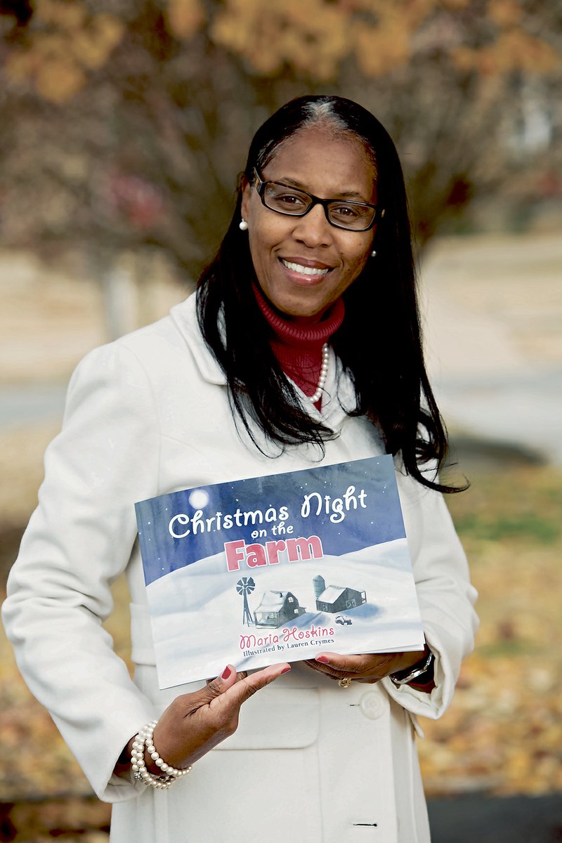 Maria Hoskins of Mayflower holds a copy of Christmas Night on the Farm, a book she self-published. She originally planned just to give a copy of the story to her mother, but Hoskins said her friend Patrick Oliver, founder of Say It Loud!, a literary-arts program, encouraged her to publish the book. Hoskins said she plans to follow the Christmas book with three more holiday stories.