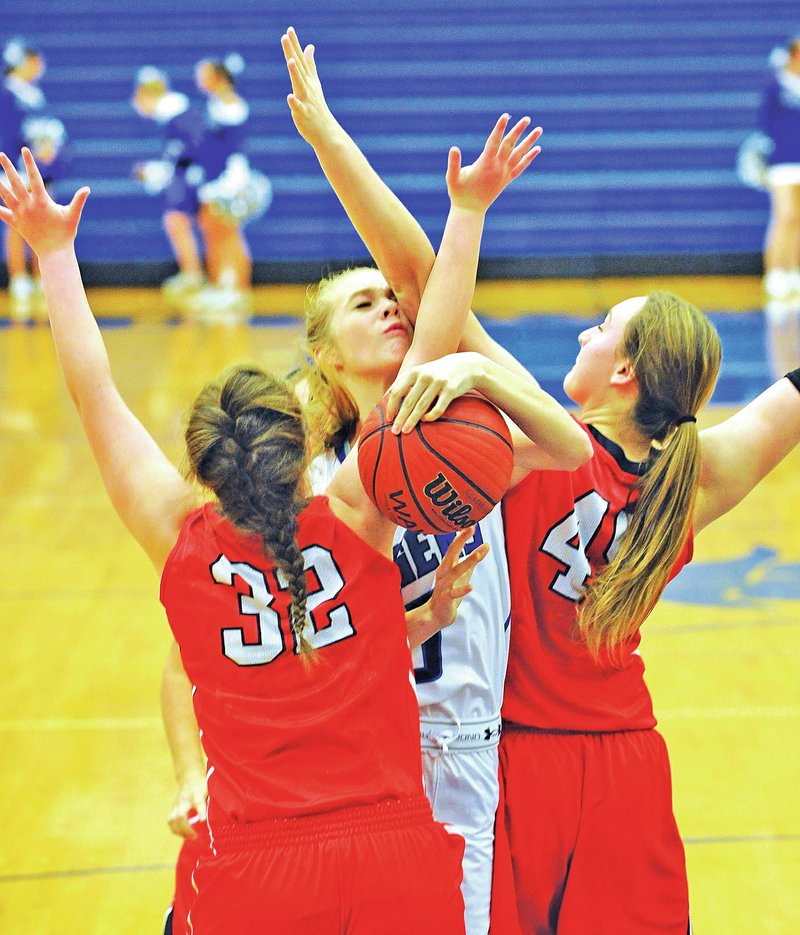 Staff Photo Michael Woods &#8226; @NWAMICHAELW Kelsey Richmond of Rogers High tries to drive past Ozark, Mo., defenders Ally Barb, left, and Kaylan Smith but is called with a charging foul during the 2014 Great 8 Classic at King Arena in Rogers.