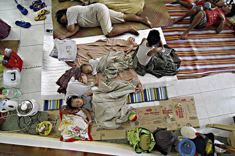 People rest Saturday at a shelter in the provincial capital, Suriago, in the central Philippines as Typhoon Hagupit bears down. 