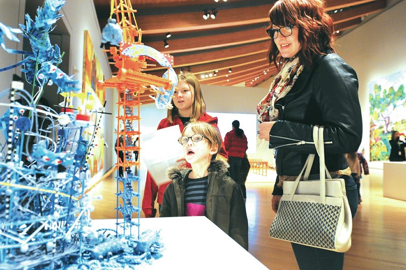 Staff Photo J.T. Wampler Melodie Schultz, right, looks at art Wednesday with her children, Mac Maynard, 5, and Mary Jayne Maynard, 12 during an outing with other Arkansas Arts Academy students to Crystal Bridges Museum of American Art in Bentonville. The school is adding more art-based instruction to classes. It&#8217;s planning on incorporating iPads and trips to Crystal Bridges and revamping curriculum at the school.