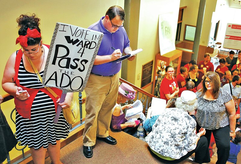 FILE PHOTO DAVID GOTTSCHALK People line the stairs of the Fayetteville City Administration Building on Aug. 19 as they wait to speak to the City Council about an anti-discrimination ordinance. The ordinance, implementing Chapter 119 of the city code, was approved but faces a referendum vote Tuesday.