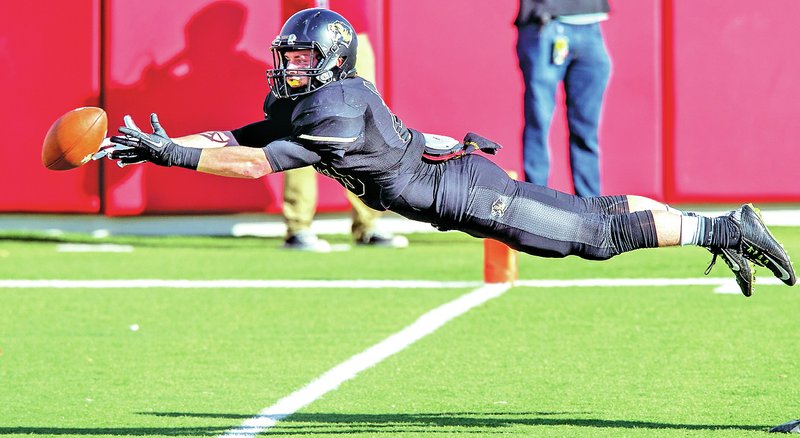 STAFF PHOTO JASON IVESTER Cody Scroggins, Bentonville senior wide receiver, lays out Saturday in attempt to make a catch in the end zone against Fayetteville in the Class 7A championship game at War Memorial Stadium in Little Rock. More photos at nwaonline.com/photos.