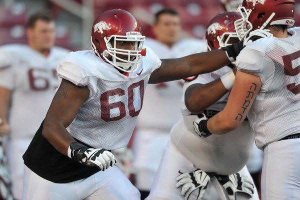 Arkansas lineman Brian Wallace runs drills during practice Aug. 13, 2014, at Razorback Stadium in Fayetteville.