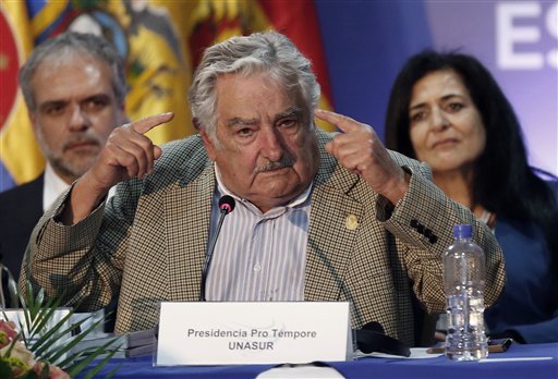New UNASUR President Jose Mujica, President of Uruguay, left, speaks during the UNASUR summit in Guayaquil, Ecuador, Thursday, Dec. 4, 2014. Mujica is reiterating his willingness to resettle six Guantanamo prisoners in his country while calling on the United States to end its decades-old embargo against Cuba. Mujica's open letter to President Barack Obama appeared Friday on his presidency website. 
