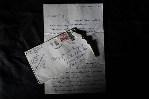 This Friday, Nov. 7, 2014 photo shows part of a three-page handwritten letter and original envelope postmarked Oct. 9, 1954 from baseball legend Joe DiMaggio to Marilyn Monroe on display at Julien's Auctions in Beverly Hills, Calif. DiMaggio's love letter to Marilyn Monroe has sold for $78,125 at a Beverly Hills auction. Julien's Auctions in Beverly Hills says the letter, written by the baseball great after Monroe announced she was divorcing him, was sold Saturday, Dec. 6, 2014, to an undisclosed buyer.