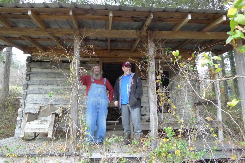 Greg Darter, left, and Gary Darter, both of Altus, stand on the front porch of what had been Mammy and Pappy Yokum's cabin at Dogpatch USA. The Darters were among thousands of people who toured the Dogpatch property in Newton County over the weekend. The Darter brothers said they had visited the park when they were kids and it was still open.