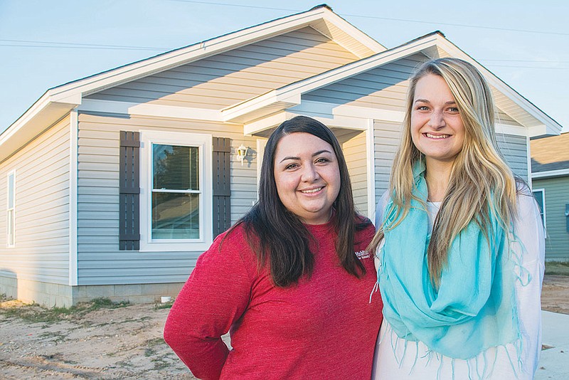 Habitat Youth United of Saline County built its fifth house in June and dedicated it Nov. 16 in Habitat for Humanity’s Partnership Village in Benton. Hollie Hughes, left, administrative and volunteer coordinator for Habitat for Humanity of Saline County, and Christina Moore, president of Habitat Youth United of Saline County, stand in front of the completed home before the dedication ceremony on Nov. 16.