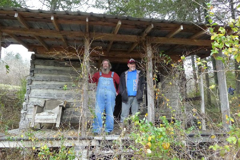 Greg Darter, left, and Gary Darter, both of Altus, stand on the front porch of what had been Mammy and Pappy Yokum's cabin while taking a tour of the Dogpatch USA property Sunday, Dec. 7, 2014, in Newton County.
