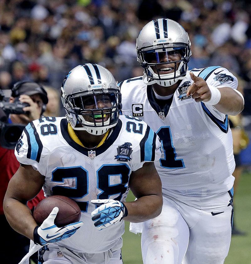 Carolina Panthers quarterback Cam Newton (1) celebrates with running back Jonathan Stewart (28) after Stewart's 69-yard touchdown carry in the second half of an NFL football game against the New Orleans Saints in New Orleans, Sunday, Dec. 7, 2014. (AP Photo/Bill Feig)