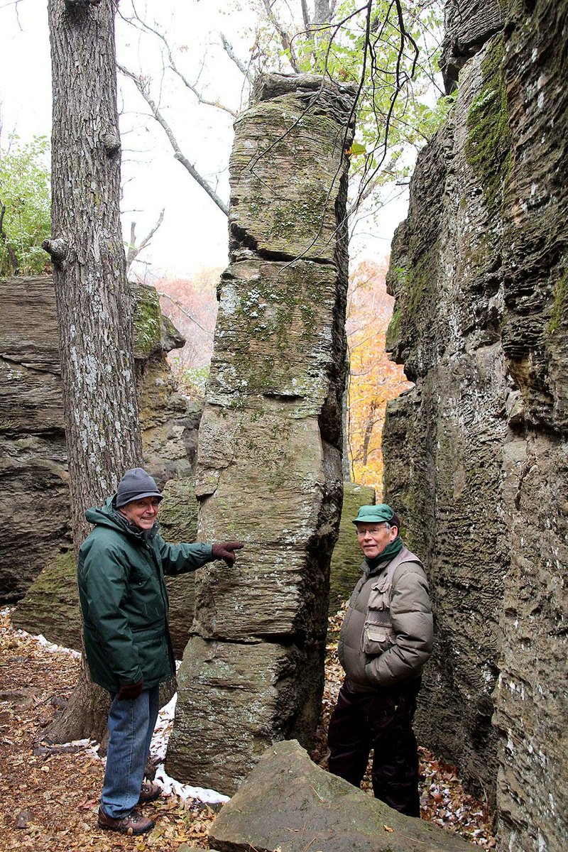 Special to the Democrat-Gazette/NANCY RANEY
Bob Caulk and Joe Neal, both of Fayetteville, explore the formations on the Rock City Trail routes on a hike with geologist Walt Manger on Kessler Mountain. The hike was sponsored by  the Fayetteville Natural Heritage Association.