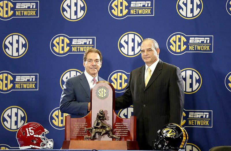 Alabama head coach Nick Saban, left, and Missouri head coach Gary Pinkel pose for photos Friday, Dec. 5, 2014, in Atlanta, ahead of the Southeastern Conference championship football game between Alabama and Missouri held Saturday. (AP Photo/Brynn Anderson)