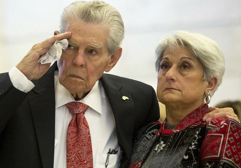 Arkansas Democrat-Gazette/MELISSA SUE GERRITS - 12/07/2014 - Kay Matthews, 92, stands with his wife Vera Matthews and salutes while taps are played in memory of lives lost during the Pearl Harbor attack December 7, 1941. The Matthews, as well as 2 other survivors,  Walter Smith, 96, and William "Bill" Chase, 90, and their family members were the guests of honor at a Pearl Harbor Ceremony hosted by the Secretary of State's office December 7, 2014 at the state capitol. 