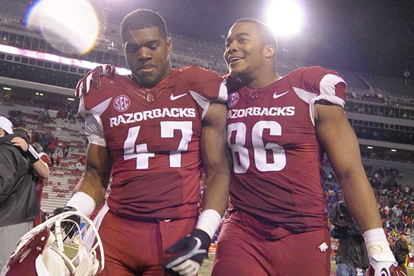 Arkansas linebacker Martrell Spaight (47) and defensive end Trey Flowers (86) walk from the field after an NCAA college football game Saturday, Nov. 22, 2014, in Fayetteville, Ark. Arkansas defeated Mississippi 30-0. (AP Photo/David Quinn)