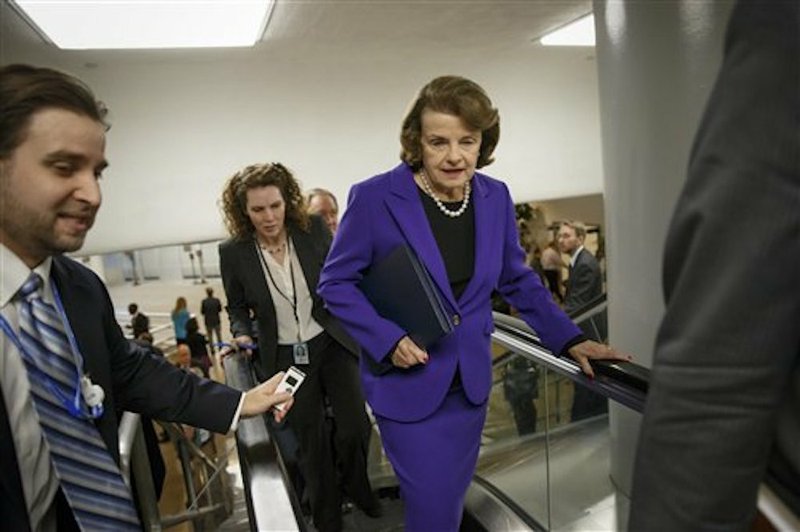 Senate Intelligence Committee Chair Sen. Dianne Feinstein, D-Calif. is pursued by reporters on Capitol Hill in Washington on Tuesday, Dec. 9, 2014, as she arrives to release a report on the CIA's harsh interrogation techniques at secret overseas facilities after the 9/11 terror attacks. 