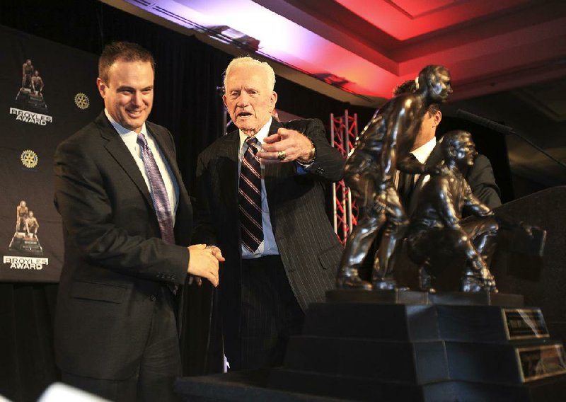 Ohio State offensive coordinator Tom Herman is congratulated by Frank Broyles after being named the winner of the Broyles Award, which is named after the former Arkansas athletic director and coach and given to the nation’s top college football assistant coach.