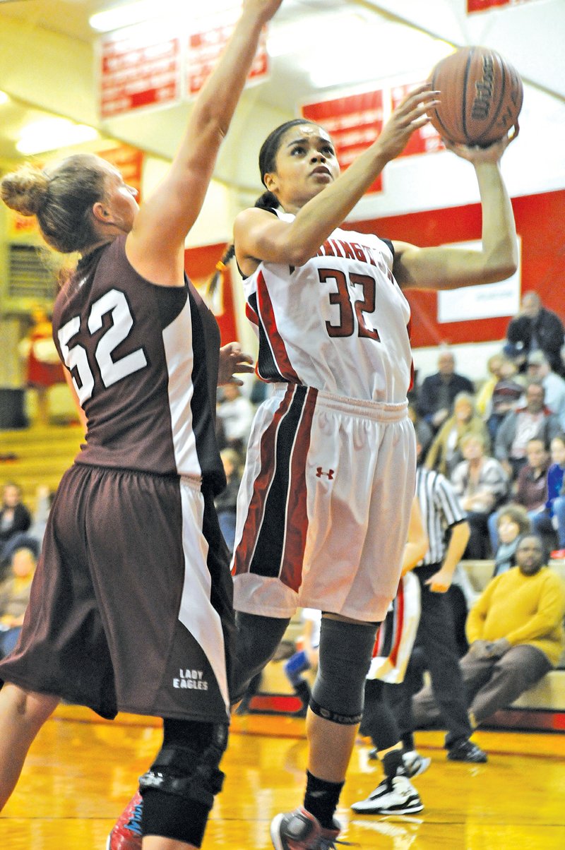  Staff Photo J.T. Wampler Tahlon Hopkins of Farmington attacks the basket while Huntsville&#8217;s Cierra Creek defends Tuesday.