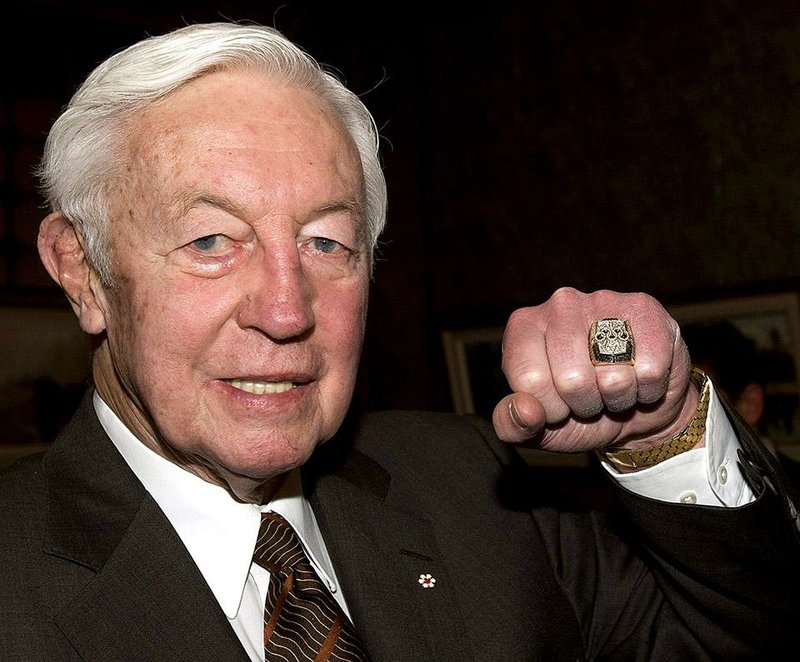 In this Dec. 14, 2010, file photo, former Montreal Canadiens hockey legend and honorary captain of the Canadian Olympic hockey team Jean Beliveau shows his Olympic ring at a ceremony in Montreal. Beliveau died Tuesday, Dec. 2, 2014. He was 83. The team confirmed the death of the Hall of Fame center and one of the most beloved players in Canadiens history. 