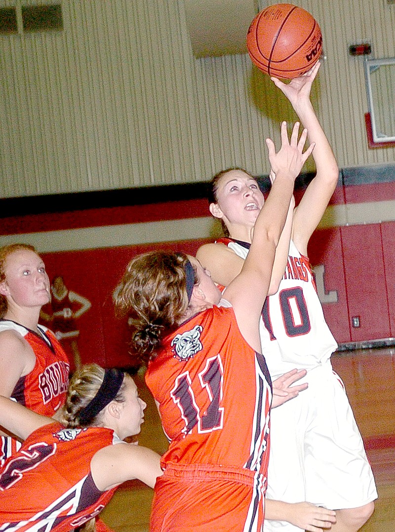 RICK PECK MCDONALD COUNTY PRESS Coley Ickes goes to the left hand for two of her 18 points in McDonald County&#8217;s 43-29 win over Carl Junction in the semifinals of the Freeman Sports Medicine CJ Classic held last week at Carl Junction High School.