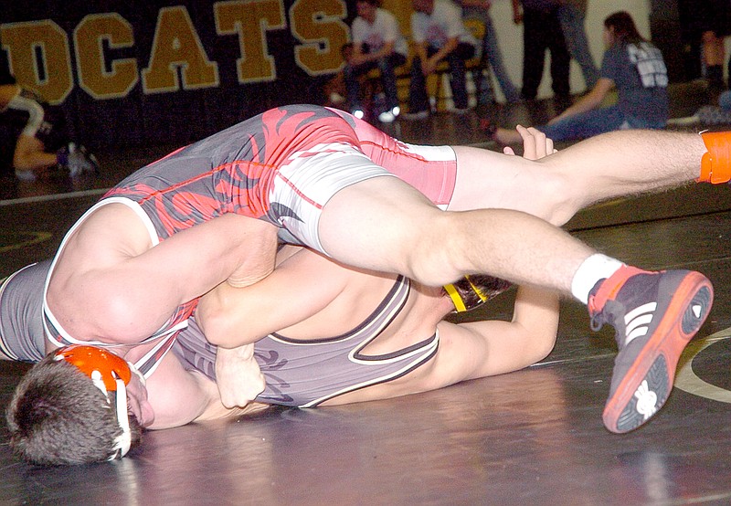 RICK PECK MCDONALD COUNTY PRESS McDonald County&#8217;s Josh Kinser nears a pin of Braxton Lewis, of Lebanon, on his way to winning the 152-pound class at the 27th Annual Neosho Wrestling Tournament held Saturday at Neosho High School.