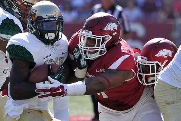 Arkansas defensive tackle Darius Philon brings down UAB running back D.J. Vinson during a game Saturday, Oct. 25, 2014 at Razorback Stadium in Fayetteville. 