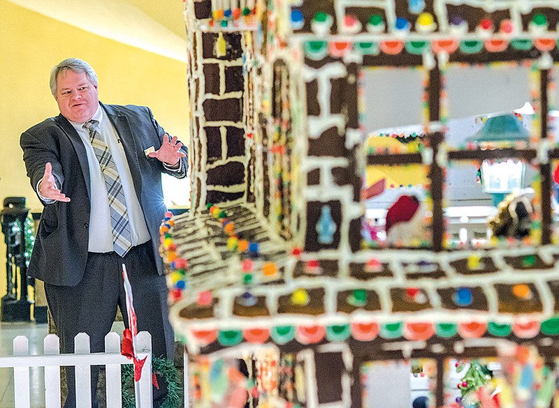 Scott Francis, director of food and beverage at the Arlington Resort Hotel and Spa in Hot Springs, gestures while talking about this year’s gingerbread house at the hotel. The Victorian-style house made by hotel chef Jean Claude Bridoux and his culinary team is just the latest creation in annual displays of gingerbread houses at the Arlington that stretch back for roughly three decades.