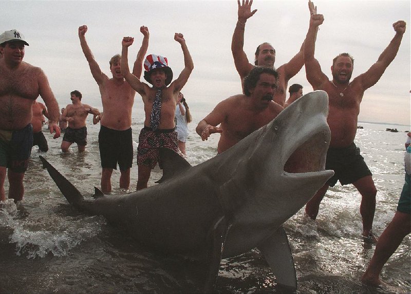 Hooting frat boys celebrate their polar plunge prank Dec. 6 at Beaver Lake. The joke could very well backfire on them.