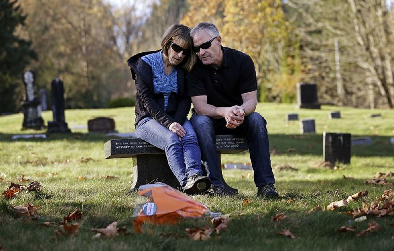 Linda and Rob Robertson visit the grave of their son, Ryan, in Issaquah, Wash. The couple are helping other evangelical parents accept their gay children. 