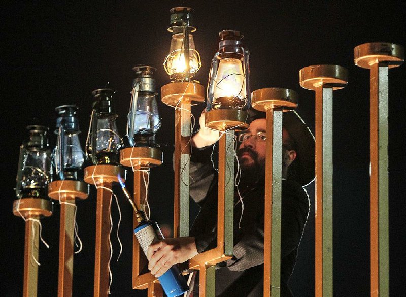 Rabbi Pinchus Ciment, director of Lubavitch of Arkansas, lights the largest menorah in Arkansas, located at the intersection of Bowman Road and Chenal Parkway in Little Rock, during Hanukkah last year.