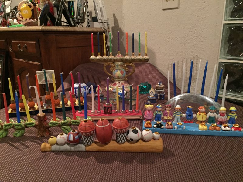 Courtesy Photo Each member of the Greer family has a personalized menorah. Twelve-year-old Jake has a sports-themed menorah, while 9-year-old Maddie has one with purple cats. The family also has received menorahs as gifts.