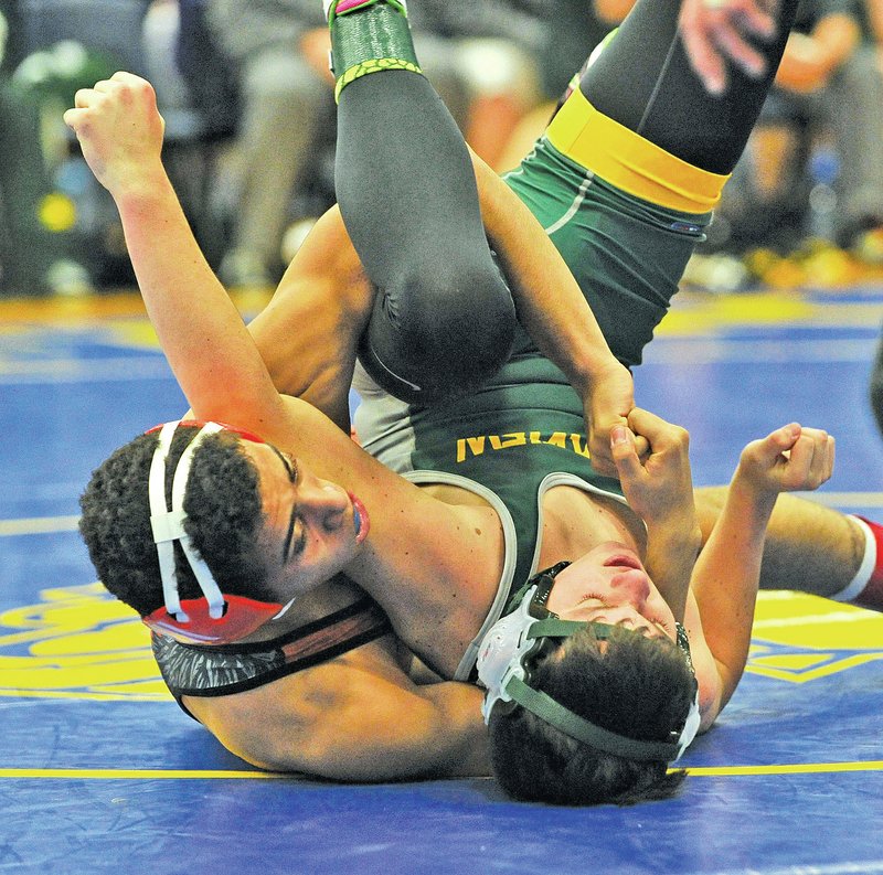  Staff Photo Michael Woods Shae Chafin of Rogers Heritage, bottom, and Hayden Graver of Little Rock Parkview compete during the NWA Duals meet Friday at Springdale Har-Ber in Springdale.