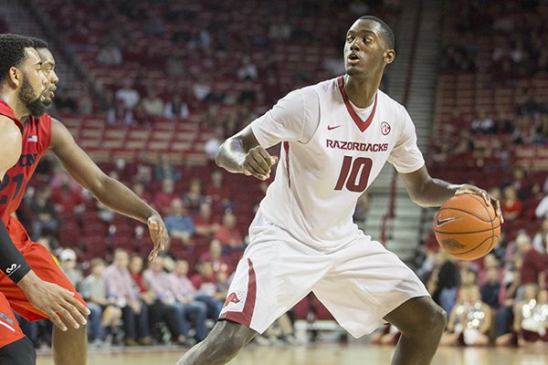 Arkansas forward Bobby Portis, right, looks to pass during second half of an NCAA college basketball game against Dayton on Saturday, Dec. 13, 2014, in Fayetteville, Ark. Arkansas defeated Dayton 69-55. (AP Photo/Gareth Patterson)