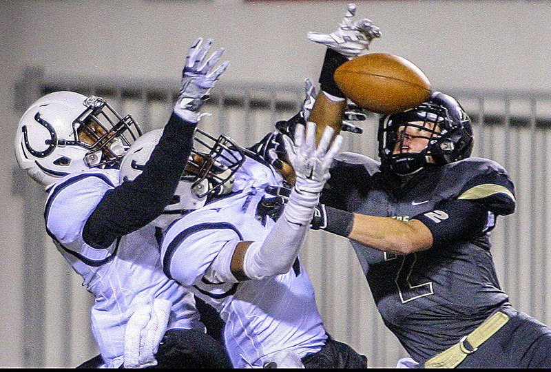 Charleston’s Jake Kuykendall (right) defends a Hail Mary heave to Smackover’s Jordan Jones (left) and Elmo Hempstead on the game’s final play. The pass fell incomplete, allowing Charleston to escape in front of 9,861 fans.