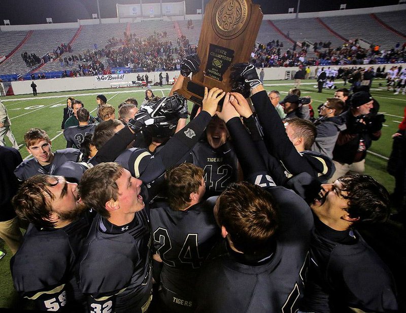 Charleston players celebrate after battling back to beat Smackover 33-26 to win the Class 3A state championship Friday at War Memorial Stadium in Little Rock. The victory gave the Tigers their second consecutive title and extended their winning streak to 29 games.