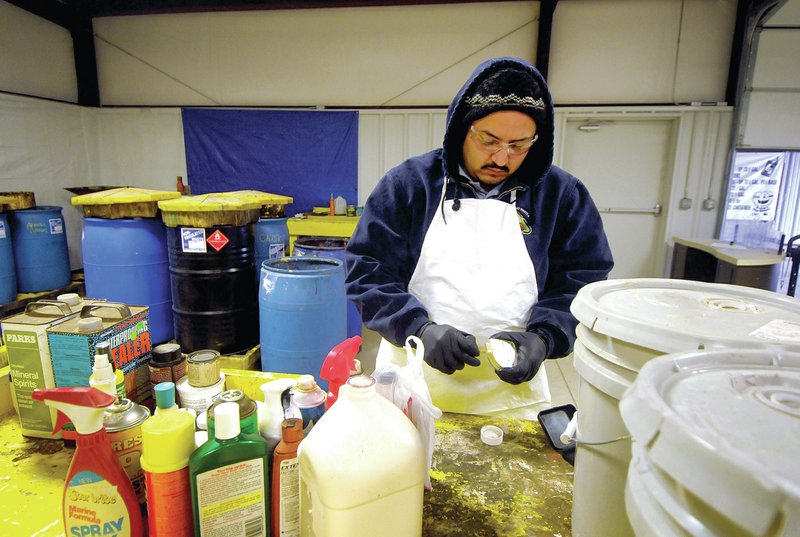 STAFF PHOTO BEN GOFF &#8226; @NWABenGoff Victor Sandoval, hazardous waste manager, demonstrates a pH test Thursday he routinely does on unknown material at the hazardous waste facility in Centerton.