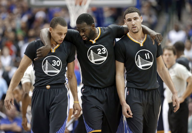 Golden State Warriors guard Stephen Curry (30), Draymond Green (23) and Klay Thompson (11) walk up court during the second half of an NBA basketball game against the Dallas Mavericks, Saturday, Dec. 13, 2014, in Dallas. Curry had 29-points, Green had 20-points and Thompson had 25-points in the 105-98 Warriors win.