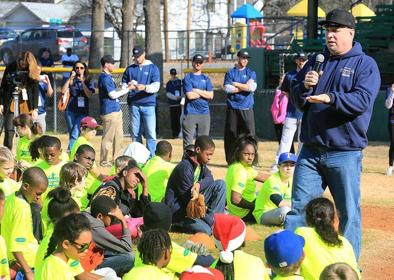 Country singer Garth Brooks talks with children at his Teammates for Kids baseball camp held Saturday at Lamar Porter Field in Little Rock. The day was about loving one another and being together, he told the kids. 