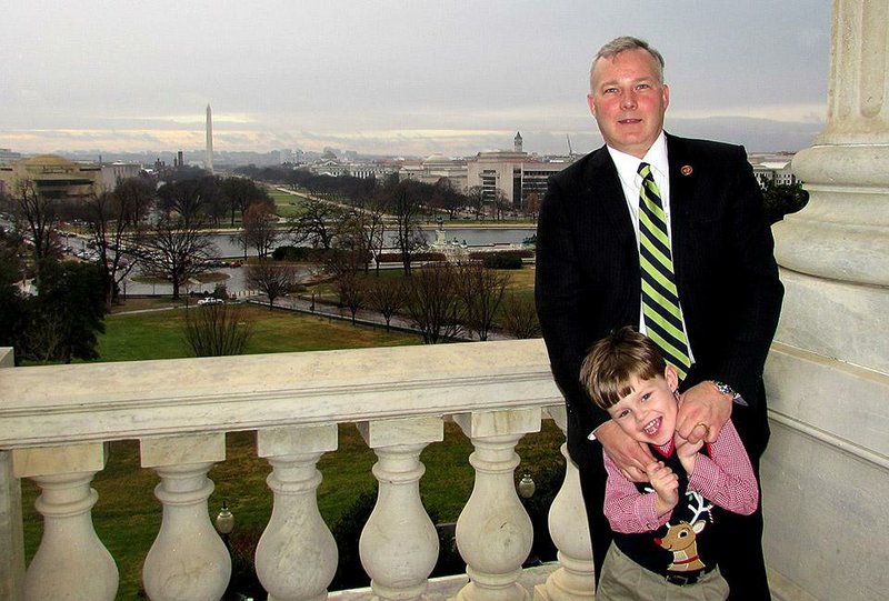 U.S. Rep. Tim Griffin and his son, John, stand Tuesday on a balcony of the U.S. Capitol as Griffin’s tenure in Congress draws to a close. 