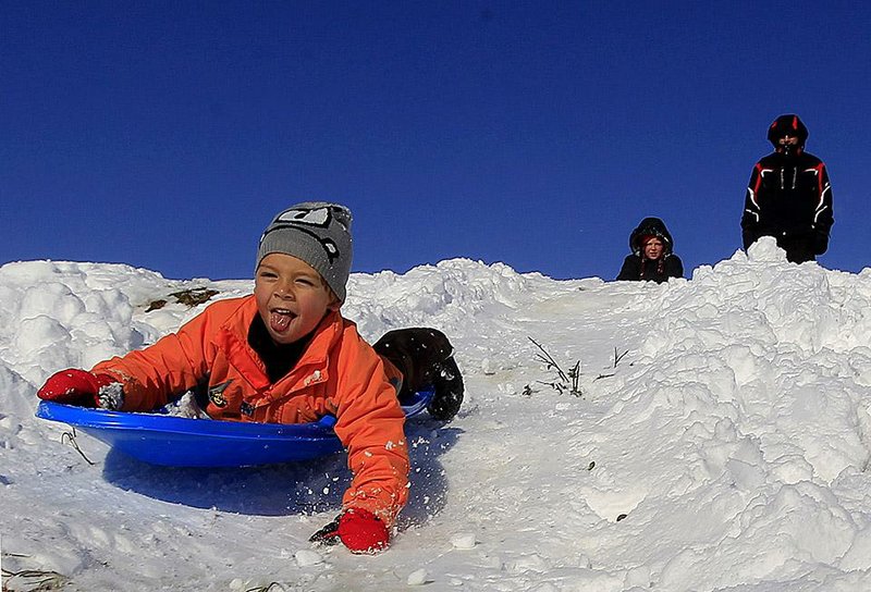 Arkansas Democrat-Gazette/BENJAMIN KRAIN --12/26/12--
Cole Harrison sleds down a hill Wednesday morning in Maumelle.  A historic Christmas night winter storm dropped upwards of a foot of snow on parts of Arkansas, shutting down workplaces, downing trees and power lines and turning travel treacherous. As of Wednesday afternoon more than 182,000 Entergy customers were without electricity. More than 90,000 of those were in Pulaski County.