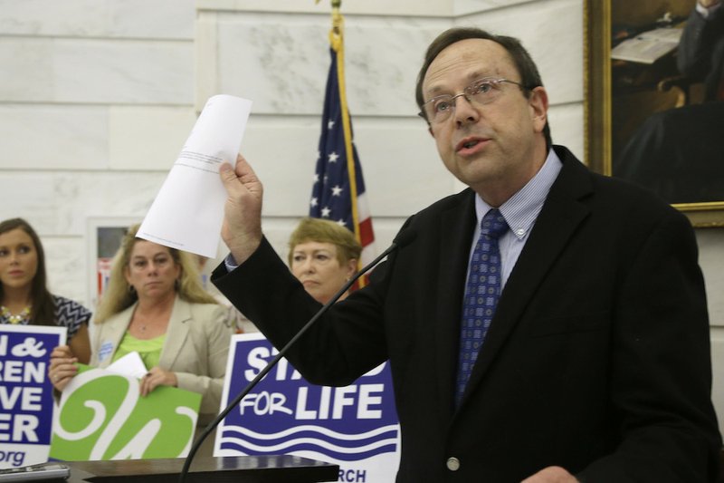 In this Aug. 29, 2014, file photo, Jerry Cox, president of Family Council, holds a copy of a letter he sent to U.S. Sen. Mark Pryor, D-Ark., at a news conference at the state Capitol in Little Rock. Some Republicans in Arkansas' Legislature are weighing measures to make it more difficult for women to get abortions. 