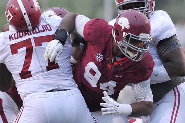 Arkansas defensive tackle Taiwan Johnson breaks through the Alabama offensive line during a game Saturday, Oct. 11, 2014 at Razorback Stadium in Fayetteville. 