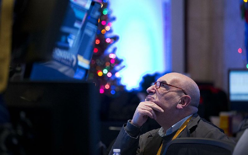A trader works on the floor of the New York Stock Exchange (NYSE) in New York,  U.S., on Monday, Dec. 15, 2014. U.S. stocks fluctuated, after the worst week in more than two years for the Standard & Poor's 500 Index, as the continuing selloff in oil prices offset a surge in industrial production and corporate deals. Photographer: Jin Lee/Bloomberg