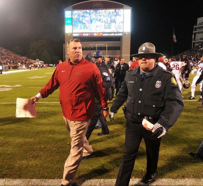 Arkansas Coach Bret Bielema (shown left) said he has talked to former Razorback Korliss Marshall about trying to resume his playing career at another college or possibly begin a professional career in the Canadian Football League.