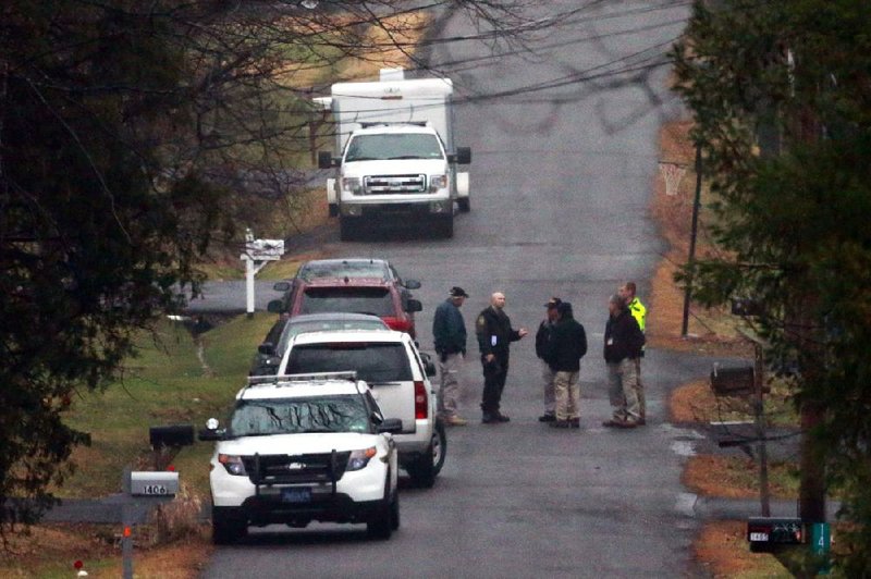 Investigators work near a wooded area Tuesday where the body of Bradley William Stone, who police said killed his ex-wife and five others, was found in Pennsburg, Pa. 