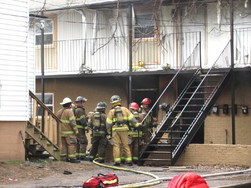 Fort Smith firefighters work at the scene of a fire that claimed the life of a 4-year-old girl Tuesday morning at an apartment on South 14th Street. 