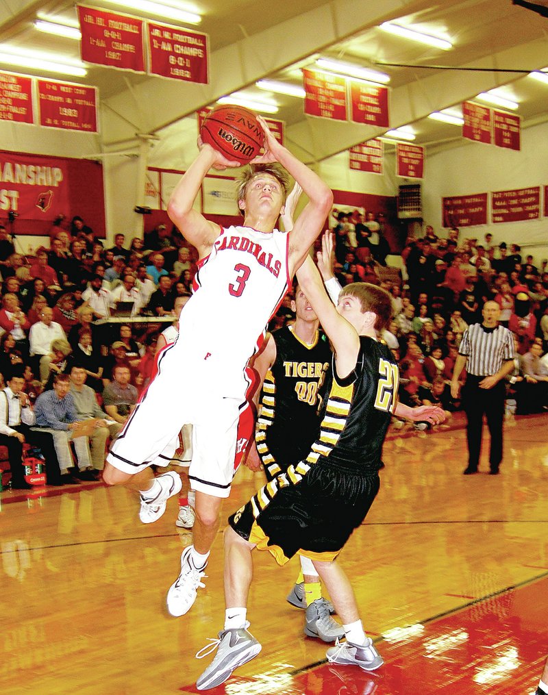 BEN MADRID ENTERPRISE-LEADER Farmington&#8217;s Jeremy Mueller goes to the basket against Prairie Grove&#8217;s Nick Ellis. Mueller scored a game-high 26 points to lead the Cardinals past the Tigers, 66-53, on Friday in the final basketball game played at Myrl Massie Arena. Farmington will open a new arena in January.