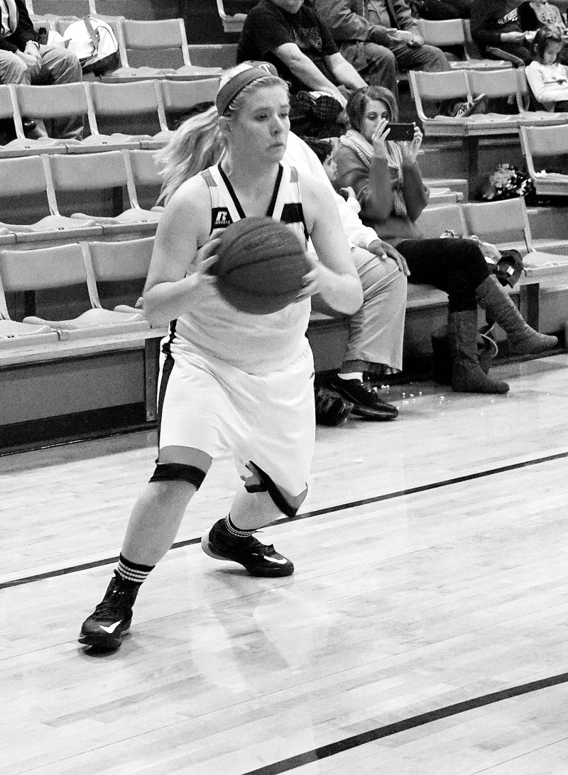 File Photo by Randy Moll Gravette junior Chasity Hubbard brings the ball down the right side of the court and passes to a teammate in recent play at Lion Field House.