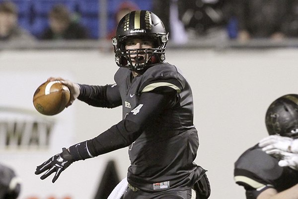 Charleston quarterback Ty Storey passes in the first quarter of the Arkansas Class 3A High School Championship football game against Smackover in Little Rock, Ark., Friday, Dec. 12, 2014. (AP Photo/Danny Johnston)