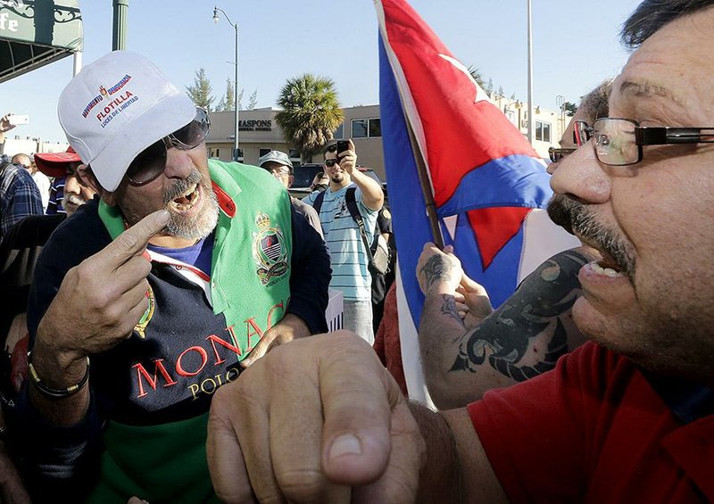 Anti-Castro protester Lazaro Lozano (left) argues with an unidentified supporter of President Barack Obama on Wednesday in the Little Havana area of Miami. 